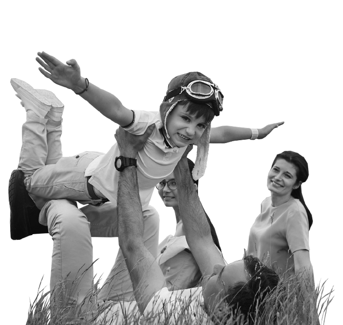 Child held up high with watching family